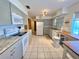 Well-lit kitchen features updated appliances, granite countertops, and ample cabinet space for storage at 760 Eastridge Dr, Orange City, FL 32763