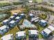 Aerial view showcases condo complex with a resort-style pool and ample parking at 7770 Sandy Ridge Dr # 207, Reunion, FL 34747