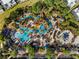 Aerial view of a resort pool with a lazy river, splashpad, and lots of seating at 7770 Sandy Ridge Dr # 207, Reunion, FL 34747