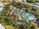 Aerial view of a resort pool with a lazy river, splashpad, and lots of seating at 7770 Sandy Ridge Dr # 207, Reunion, FL 34747