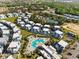 Stunning aerial view of a resort community featuring modern homes, swimming pools, mature trees, and lush landscaping at 7770 Sandy Ridge Dr # 207, Reunion, FL 34747