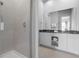 Modern bathroom with a glass-enclosed shower and double vanity at 7770 Sandy Ridge Dr # 207, Reunion, FL 34747