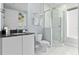 Modern bathroom featuring a glass-enclosed shower, white tile, and sleek fixtures at 7770 Sandy Ridge Dr # 207, Reunion, FL 34747