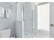A beautifully updated bathroom features a glass enclosed shower and white towels at 7770 Sandy Ridge Dr # 207, Reunion, FL 34747
