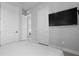 Inviting bedroom featuring doors to walk in closet, bathroom and TV at 7770 Sandy Ridge Dr # 207, Reunion, FL 34747