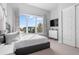 Bright bedroom showcasing a large window, TV, dresser, and comfortable bed at 7770 Sandy Ridge Dr # 207, Reunion, FL 34747