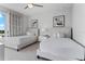 Elegant bedroom featuring two twin beds, soft carpet, a ceiling fan, and contemporary artwork at 7770 Sandy Ridge Dr # 207, Reunion, FL 34747