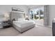 Bright bedroom with a large window and upholstered headboard at 7770 Sandy Ridge Dr # 207, Reunion, FL 34747
