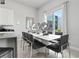 Modern dining room with large windows and stylish decor at 7770 Sandy Ridge Dr # 207, Reunion, FL 34747