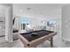 Open-concept game room with a pool table, balcony, and modern furniture at 7770 Sandy Ridge Dr # 207, Reunion, FL 34747