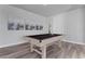 Spacious game room with a well-lit pool table, stylish decor, and neutral walls at 7770 Sandy Ridge Dr # 207, Reunion, FL 34747
