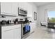 Modern kitchen featuring stainless steel appliances, gray countertops, and white cabinetry at 7770 Sandy Ridge Dr # 207, Reunion, FL 34747