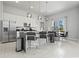 Modern open concept kitchen featuring sleek white cabinetry, stainless steel appliances, and a stylish dining area at 7770 Sandy Ridge Dr # 207, Reunion, FL 34747