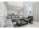 Bright and spacious living area features soaring ceilings, an expansive gray sofa, and contemporary decor at 7770 Sandy Ridge Dr # 207, Reunion, FL 34747