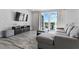 Cozy living room with a gray sectional, TV, and sliding glass doors to a balcony at 7770 Sandy Ridge Dr # 207, Reunion, FL 34747