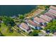 Aerial view of multi-level homes with private docks on a scenic lake in a lush community at 8125 Via Rosa, Orlando, FL 32836