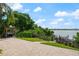 Spacious backyard with a lake view, cooking area, and private boat dock at 8125 Via Rosa, Orlando, FL 32836
