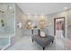 This luxury bathroom features marble floors and walls, double sinks, and glass shower at 8125 Via Rosa, Orlando, FL 32836