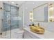 Stylish bathroom with a golden sink, blue tiled shower, and elegant gold fixtures at 8125 Via Rosa, Orlando, FL 32836