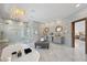 This luxury bathroom features marble floors and walls, a decorative chandelier, and double sinks at 8125 Via Rosa, Orlando, FL 32836