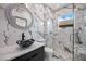This bathroom features a glass shower enclosure, round mirror, and modern black sink at 8125 Via Rosa, Orlando, FL 32836