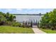 Lakeside dock and deck area with wrought iron fencing and beautiful plants at 8125 Via Rosa, Orlando, FL 32836