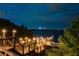 Illuminated lakeside dock with waterfront view and skyline at night at 8125 Via Rosa, Orlando, FL 32836