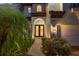 Elegant entryway showcasing a decorative glass front door and manicured landscaping at 8125 Via Rosa, Orlando, FL 32836