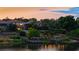 Waterfront homes with private docks are enhanced by landscape lighting reflected in the tranquil lake at twilight at 8125 Via Rosa, Orlando, FL 32836