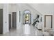 Bright foyer with high ceilings, marble floors, and staircase with black railing at 8125 Via Rosa, Orlando, FL 32836
