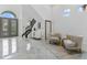 Grand foyer featuring high ceilings, elegant decor, and marble floors for a luxurious entrance at 8125 Via Rosa, Orlando, FL 32836