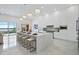 Bright, modern kitchen featuring a marble island, sleek white cabinets, and luxury pendant lighting at 8125 Via Rosa, Orlando, FL 32836