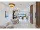 Expansive living room with marble floors, modern chandeliers, and a view of the water at 8125 Via Rosa, Orlando, FL 32836