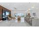 Open concept living room with marble floors and views of outdoor pool and water at 8125 Via Rosa, Orlando, FL 32836