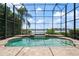 Relaxing screened-in pool with spill-over spa and waterfront views at 8125 Via Rosa, Orlando, FL 32836