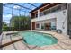 Home's private screened-in pool and hot tub alongside balcony with waterfront views at 8125 Via Rosa, Orlando, FL 32836