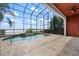 Enjoy swimming year round in this large enclosed in-ground pool with waterfront views at 8125 Via Rosa, Orlando, FL 32836