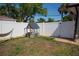 Fenced backyard with a playhouse and ample space for outdoor activities at 900 S Maple Ave, Sanford, FL 32771