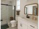 Modern bathroom with marble-tiled shower, white vanity, and sleek black fixtures at 900 S Maple Ave, Sanford, FL 32771
