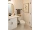 Cozy half bath with a white vanity, toilet, and neutral decor at 900 S Maple Ave, Sanford, FL 32771