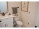 Stylish half bathroom with a modern vanity, toilet, and decorative accents at 900 S Maple Ave, Sanford, FL 32771