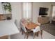 Cozy dining area with a wooden table, modern chairs, and adjacent living space at 900 S Maple Ave, Sanford, FL 32771