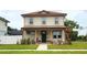 Charming two-story home featuring a cozy front porch and well-manicured lawn at 900 S Maple Ave, Sanford, FL 32771