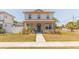 Inviting two-story home with a cozy front porch and lush green lawn at 900 S Maple Ave, Sanford, FL 32771
