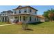 Charming two-story home with a cozy front porch, rocking chairs, and well-maintained landscaping at 900 S Maple Ave, Sanford, FL 32771