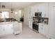 Modern kitchen with white cabinets, stainless steel appliances, and an island at 900 S Maple Ave, Sanford, FL 32771