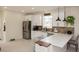 Bright kitchen featuring white cabinets, stainless steel appliances, quartz countertops, and a garden window at 900 S Maple Ave, Sanford, FL 32771