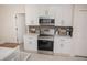 Modern kitchen with stainless steel appliances, white cabinets, and stylish backsplash at 900 S Maple Ave, Sanford, FL 32771