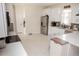Bright kitchen featuring white cabinetry, stainless steel appliances, and tile flooring at 900 S Maple Ave, Sanford, FL 32771