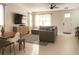 Comfortable living room with a sectional sofa, TV, and neutral color scheme, filled with natural light at 900 S Maple Ave, Sanford, FL 32771
